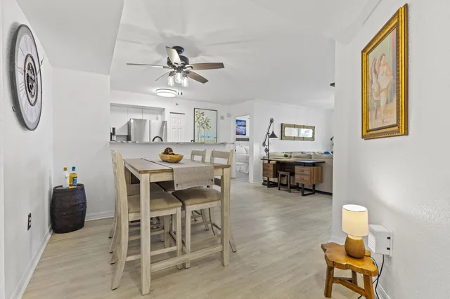 a view of a dining room with furniture and a chandelier