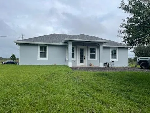 a view of a house with backyard porch and garden