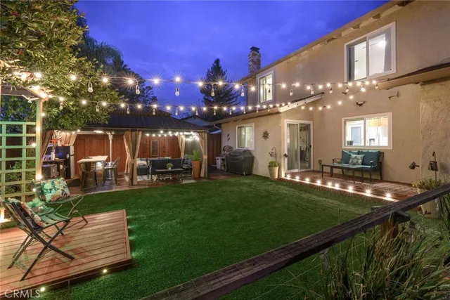 a view of a patio with couches table and chairs and potted plants