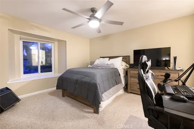 a spacious bedroom with a bed and a chandelier