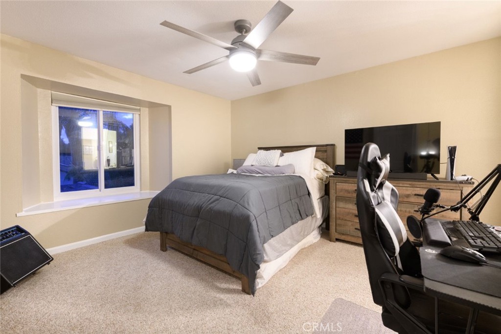 6565 Princevalle Street Gilroy, CA 95020 - Photo 17 of 27 a spacious bedroom with a bed and a chandelier