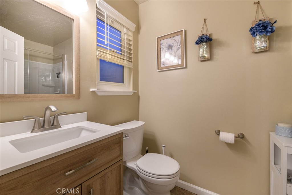 6565 Princevalle Street Gilroy, CA 95020 - Photo 19 of 27 a bathroom with a sink mirror and toilet