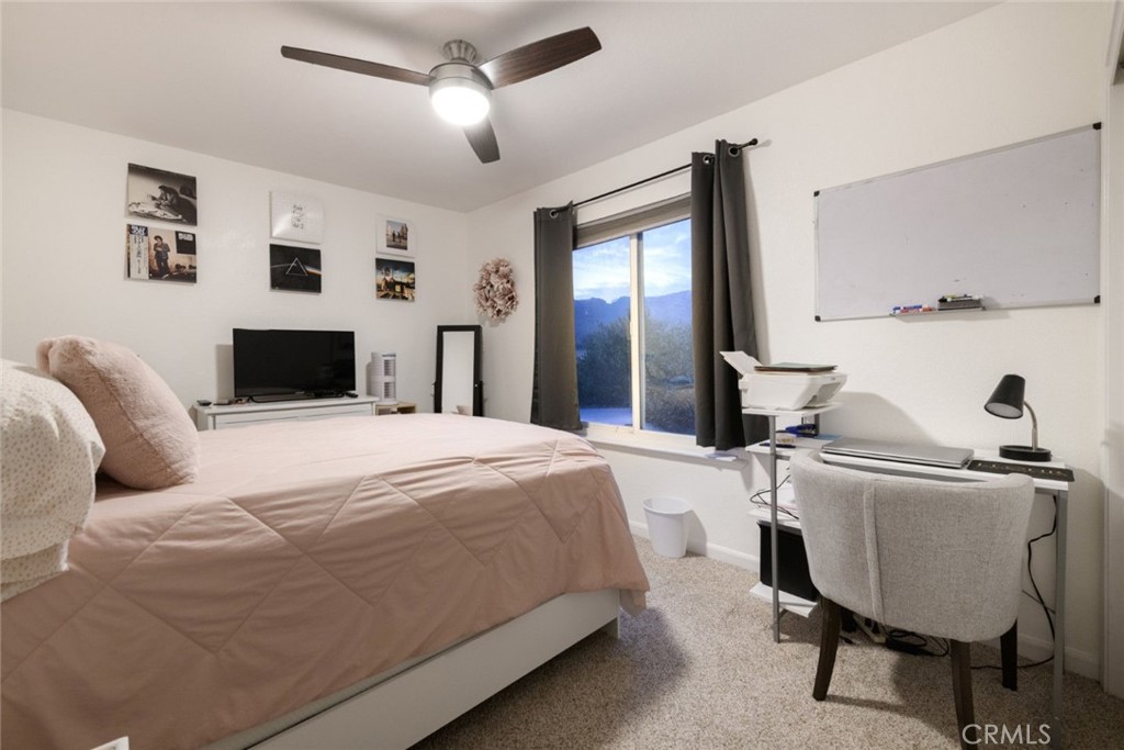 6565 Princevalle Street Gilroy, CA 95020 - Photo 21 of 27 a bedroom with a bed and wooden floor