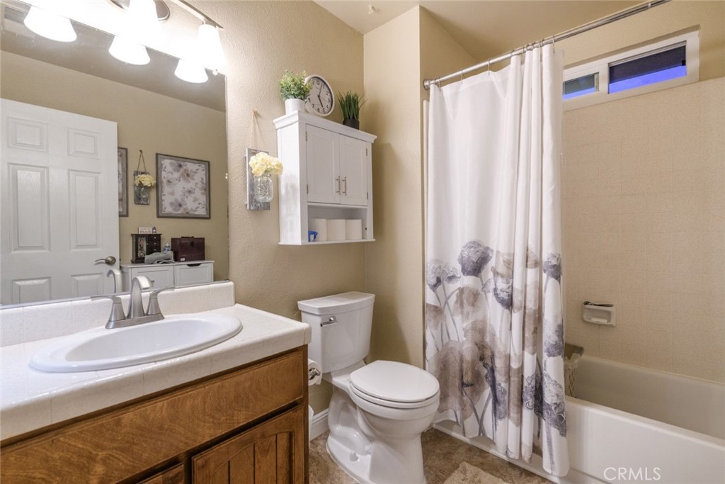 6565 Princevalle Street Gilroy, CA 95020 - Photo 22 of 27 a bathroom with a sink toilet and shower