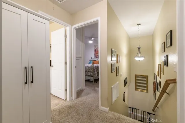 a view of a hallway with wooden floor and windows
