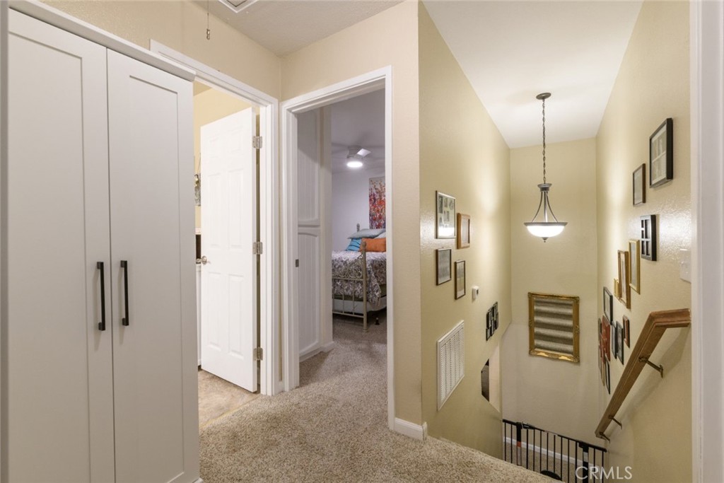 6565 Princevalle Street Gilroy, CA 95020 - Photo 23 of 27 a view of a hallway with wooden floor and windows