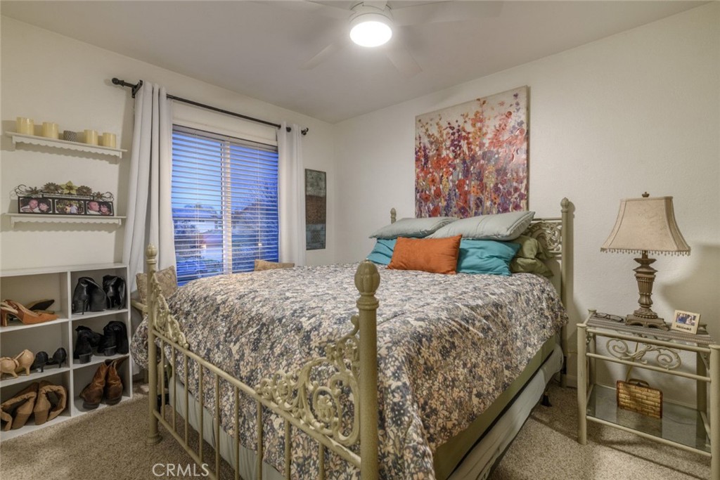 6565 Princevalle Street Gilroy, CA 95020 - Photo 24 of 27 a bedroom with a bed and a cabinets