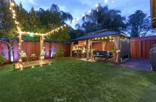 a view of a chair and table in back yard of the house