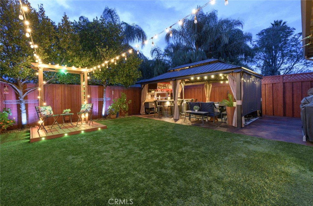 6565 Princevalle Street Gilroy, CA 95020 - Photo 5 of 27 a view of a chair and table in back yard of the house