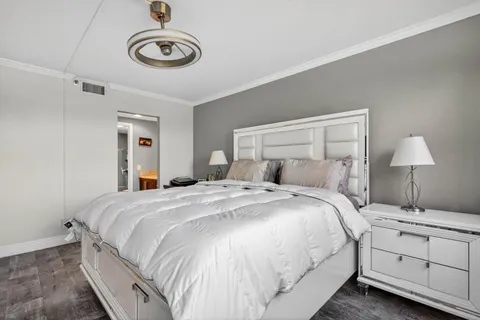 a bedroom with a bed and a chandelier