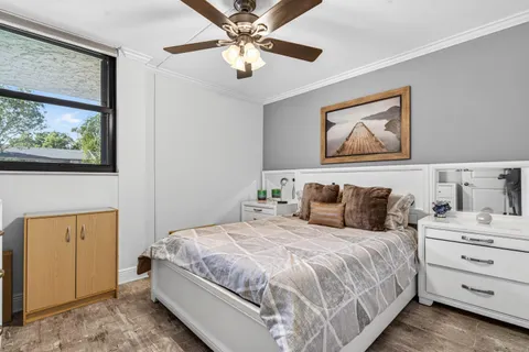 a bedroom with a bed and a painting on the wall