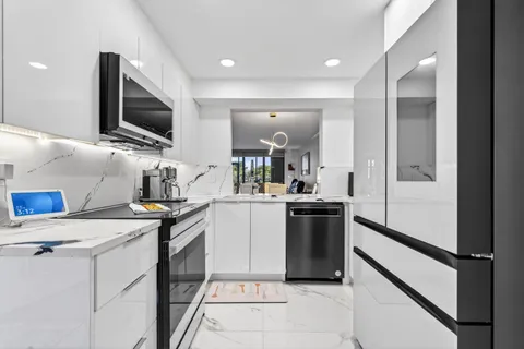 a kitchen with a sink stainless steel appliances and cabinets