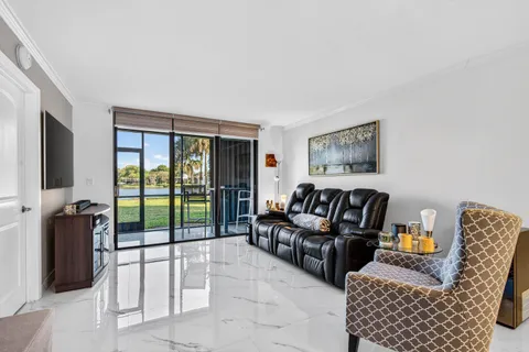 a living room with furniture and a floor to ceiling window
