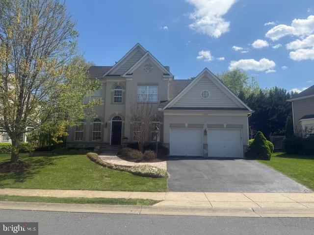 11007 Country Club Road New Market, MD 21774 - Photo 2 of 6 a front view of a house with a yard and garage