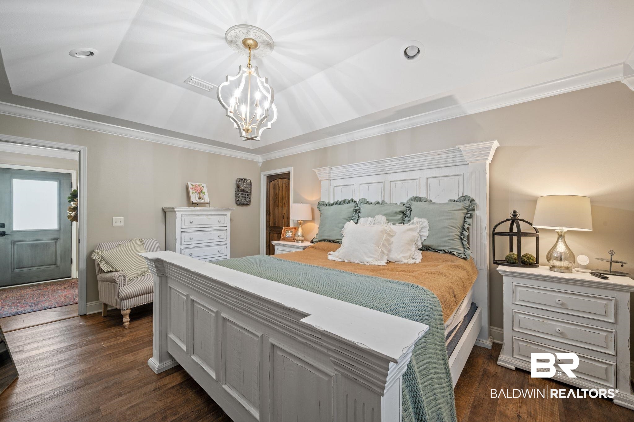 38211-d) V R Byrd Road Bay Minette, AL 36507 - Photo 18 of 58 Bedroom featuring lofted ceiling, dark wood-type flooring, a raised ceiling, ornamental molding, and a notable chandelier