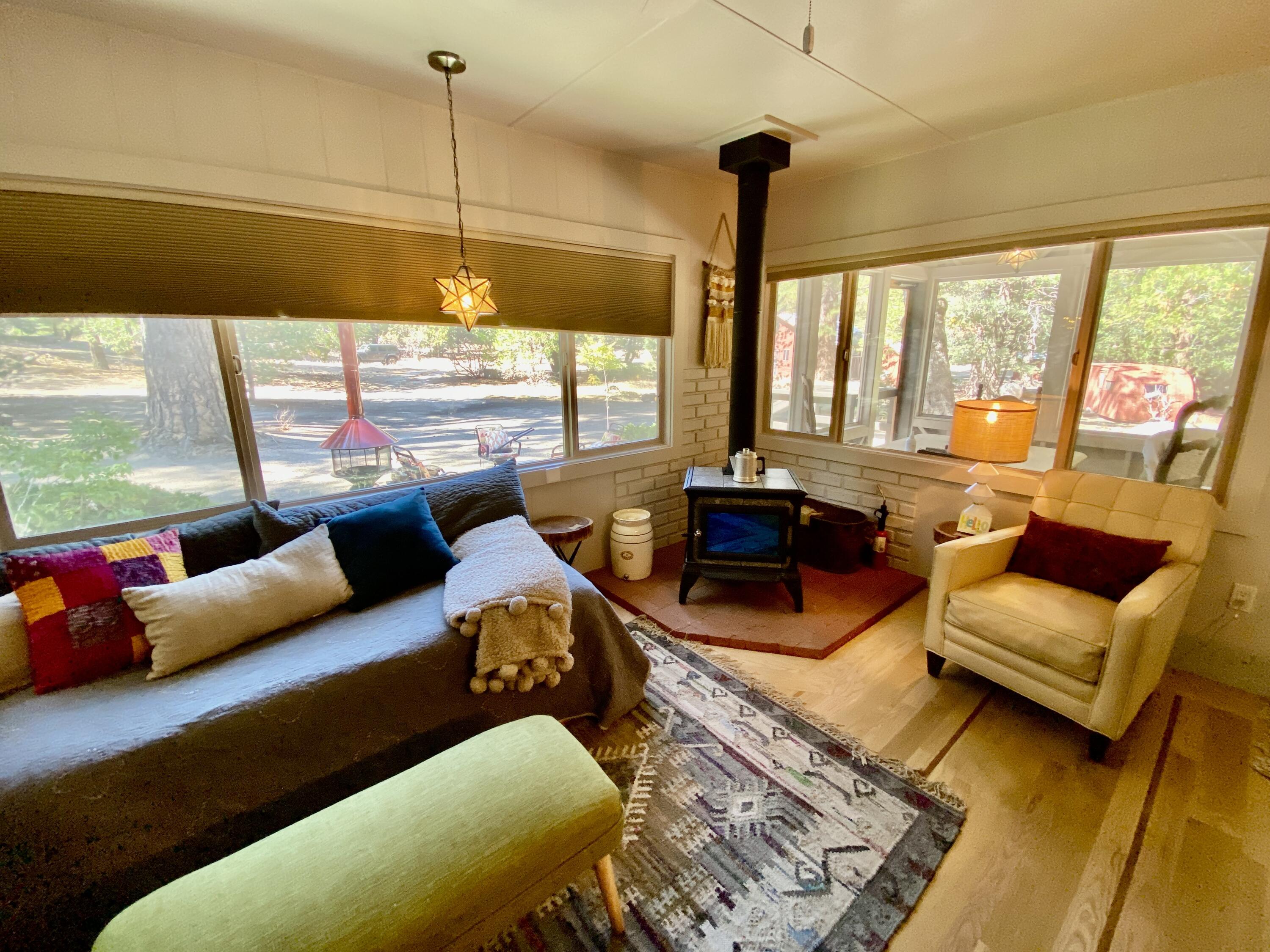 53080 4s02 Idyllwild, CA 92549 - Photo 11 of 77 a living room with furniture and a floor to ceiling window