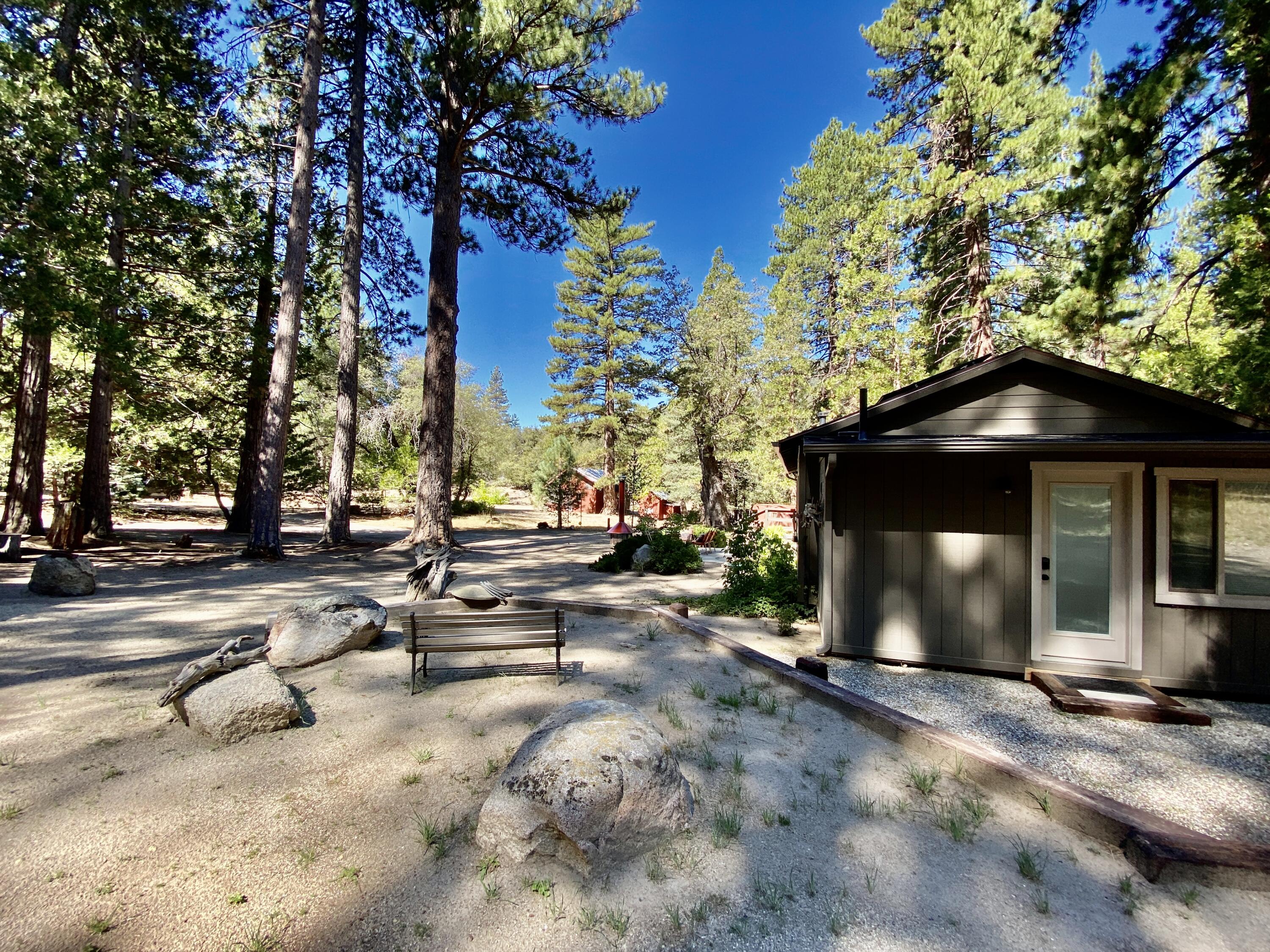 53080 4s02 Idyllwild, CA 92549 - Photo 27 of 77 a view of a patio with a table and chairs under an umbrella