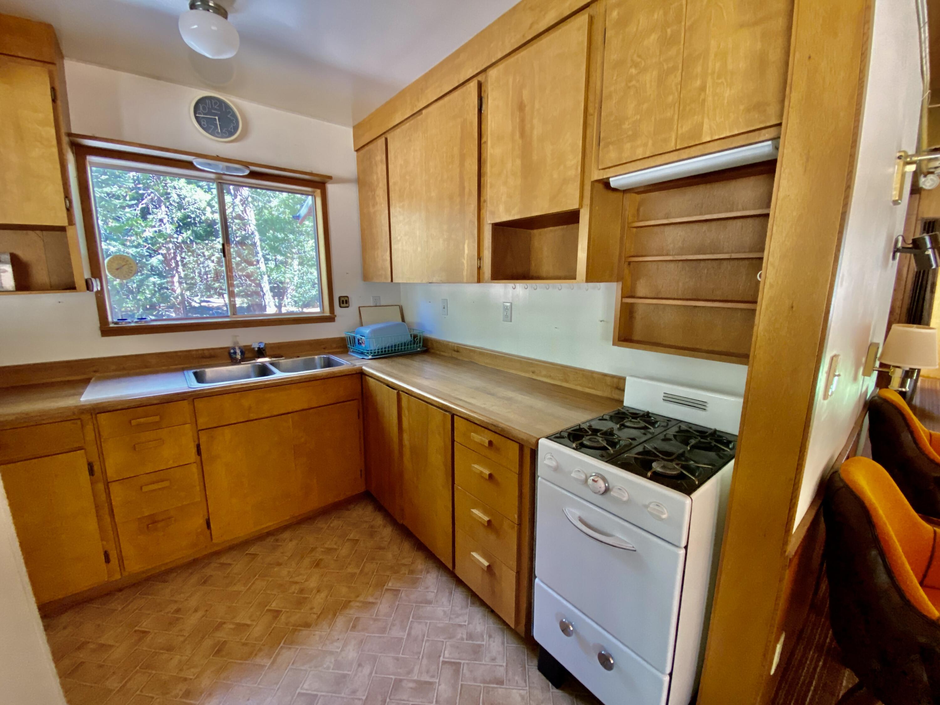 53080 4s02 Idyllwild, CA 92549 - Photo 45 of 77 a kitchen with stainless steel appliances granite countertop a stove a sink and a refrigerator