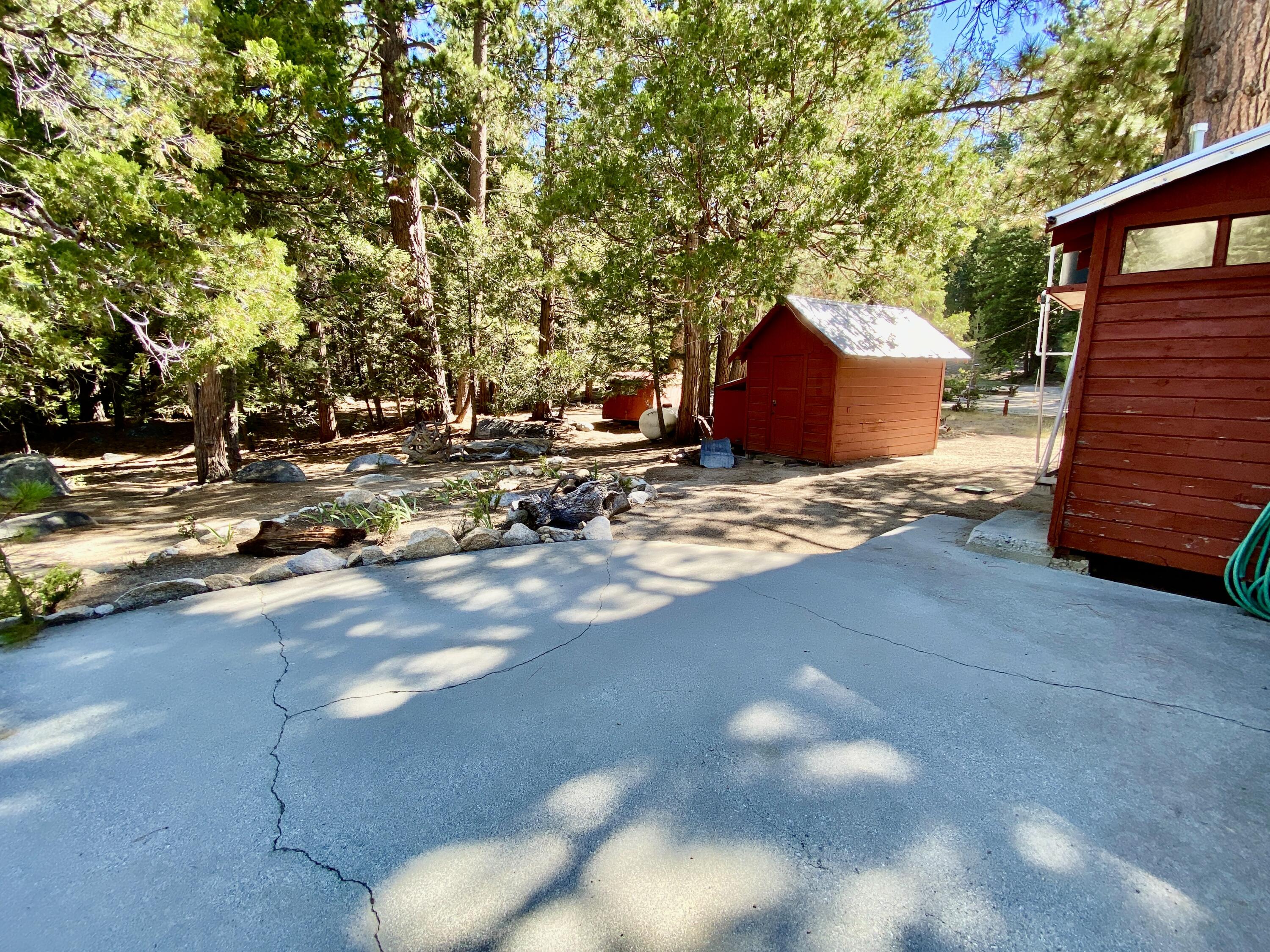 53080 4s02 Idyllwild, CA 92549 - Photo 62 of 77 a backyard of a house with trees and outdoor seating