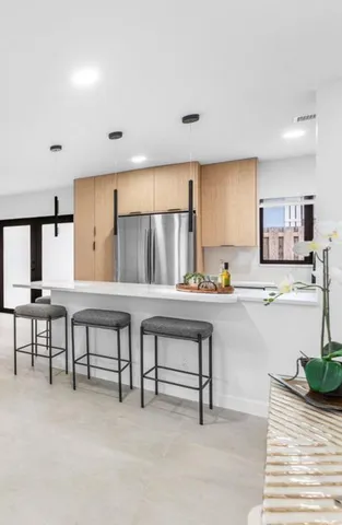 a open kitchen with white cabinets and stainless steel appliances