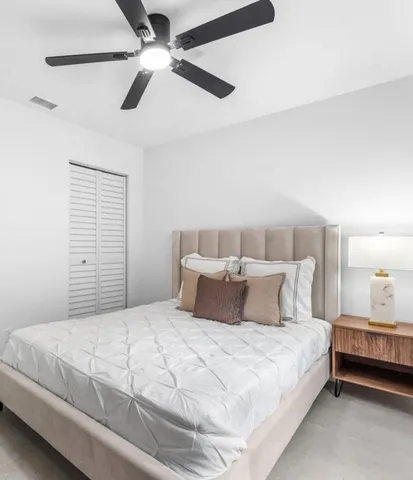 a bedroom with a large bed and a window