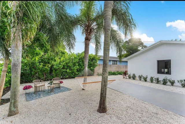 a backyard of a house with lots of green space and fountain