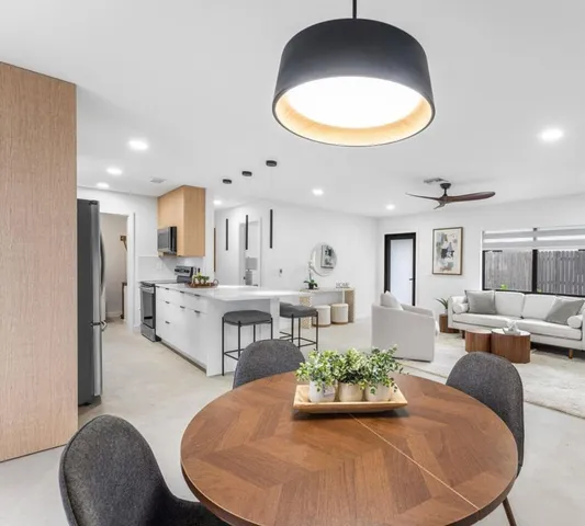 a living room with kitchen island furniture and a chandelier