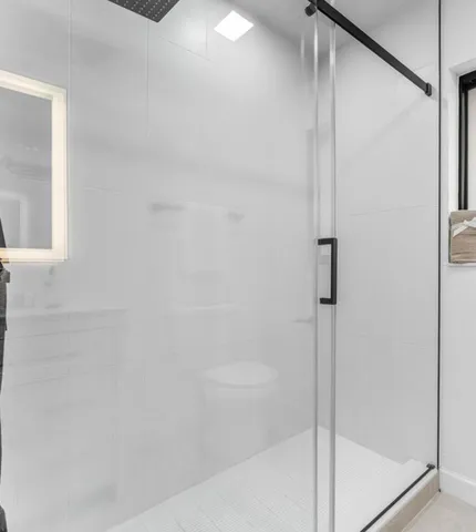 a bedroom with a bed and a ceiling fan