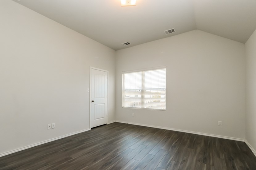 1003 Harper Lane Bryan, TX 77803 - Photo 11 of 15 an empty room with wooden floor and window