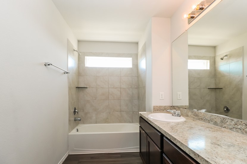1003 Harper Lane Bryan, TX 77803 - Photo 12 of 15 a bathroom with a granite countertop sink toilet and shower