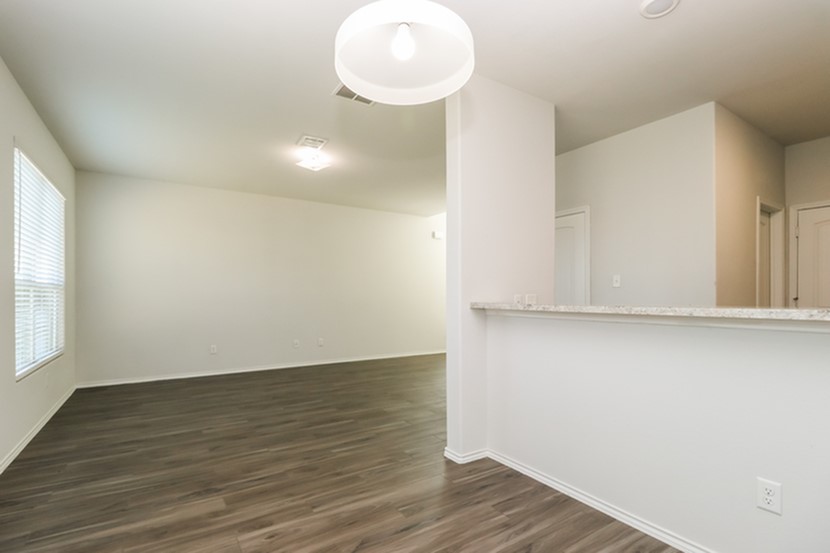 1003 Harper Lane Bryan, TX 77803 - Photo 7 of 15 a view of an empty room with wooden floor and a window