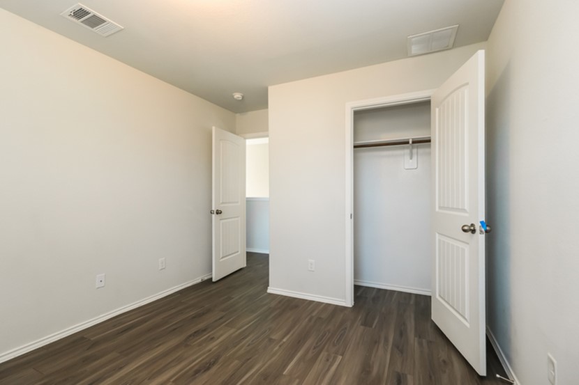 1003 Harper Lane Bryan, TX 77803 - Photo 8 of 15 an empty room with wooden floor & closet area