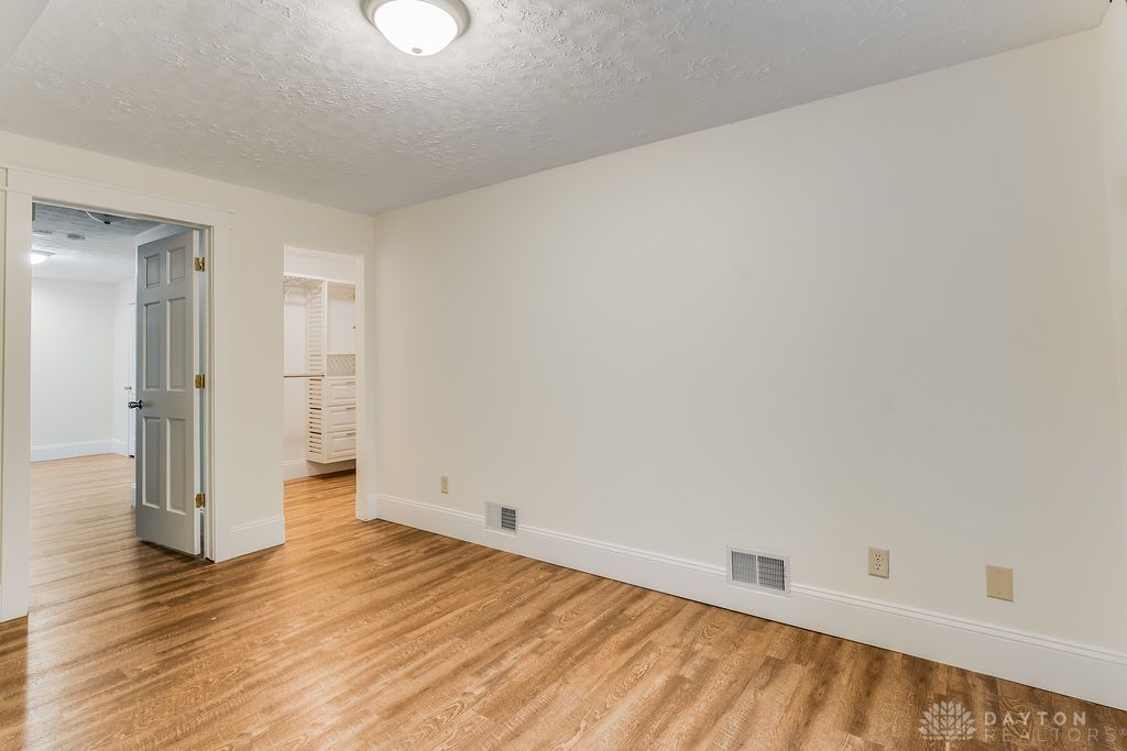 7400 Cook-Jones Road Waynesville, OH 45068 - Photo 50 of 72 This inviting bedroom features rich hardwood flooring and a functional walk-in closet.