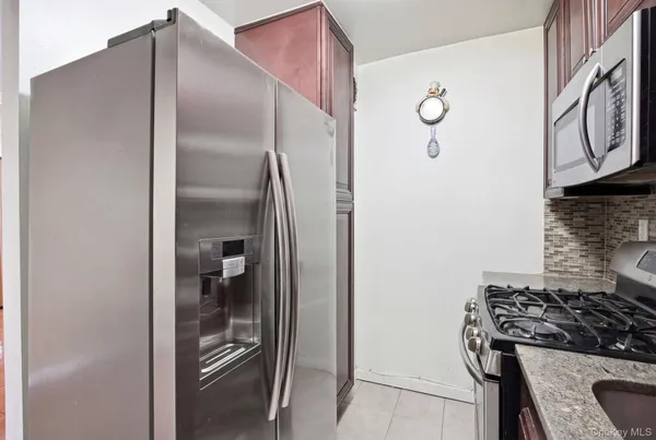 a kitchen with a refrigerator and a stove