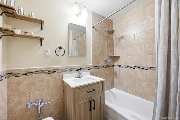 a bathroom with a shower and a sink