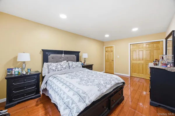 a bedroom with a bed and a dresser