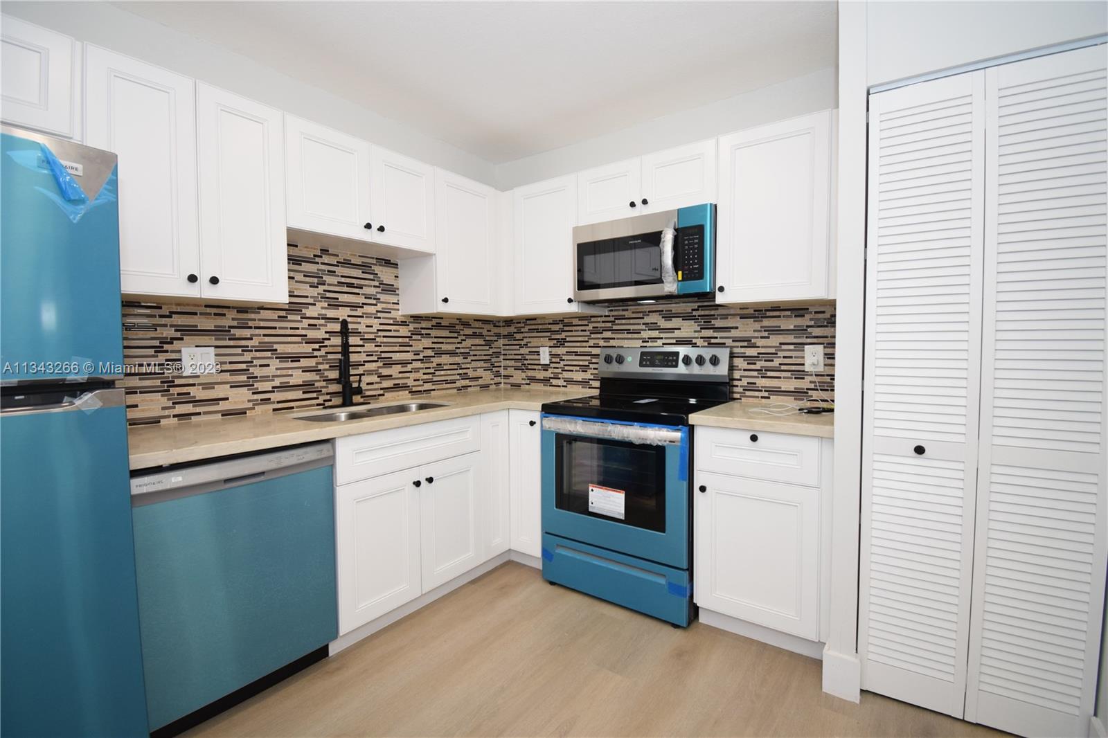 9222 Southwest 5th Street, Unit A Boca Raton, FL 33428 - Photo 5 of 34 a kitchen with stainless steel appliances granite countertop a stove and a sink
