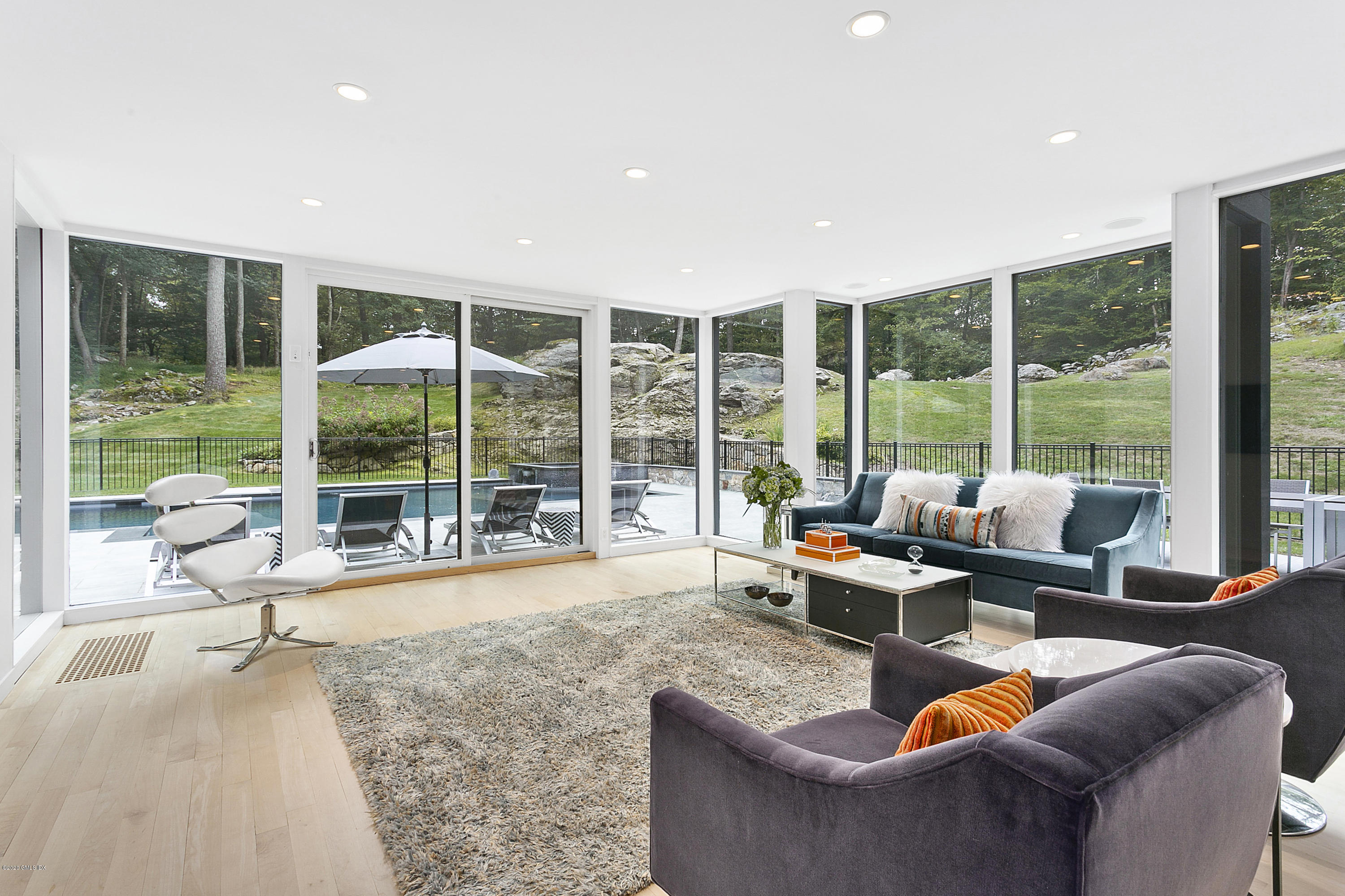 9 Chateau Ridge Drive Greenwich, CT 06831 - Photo 12 of 34 a living room with furniture and floor to ceiling windows