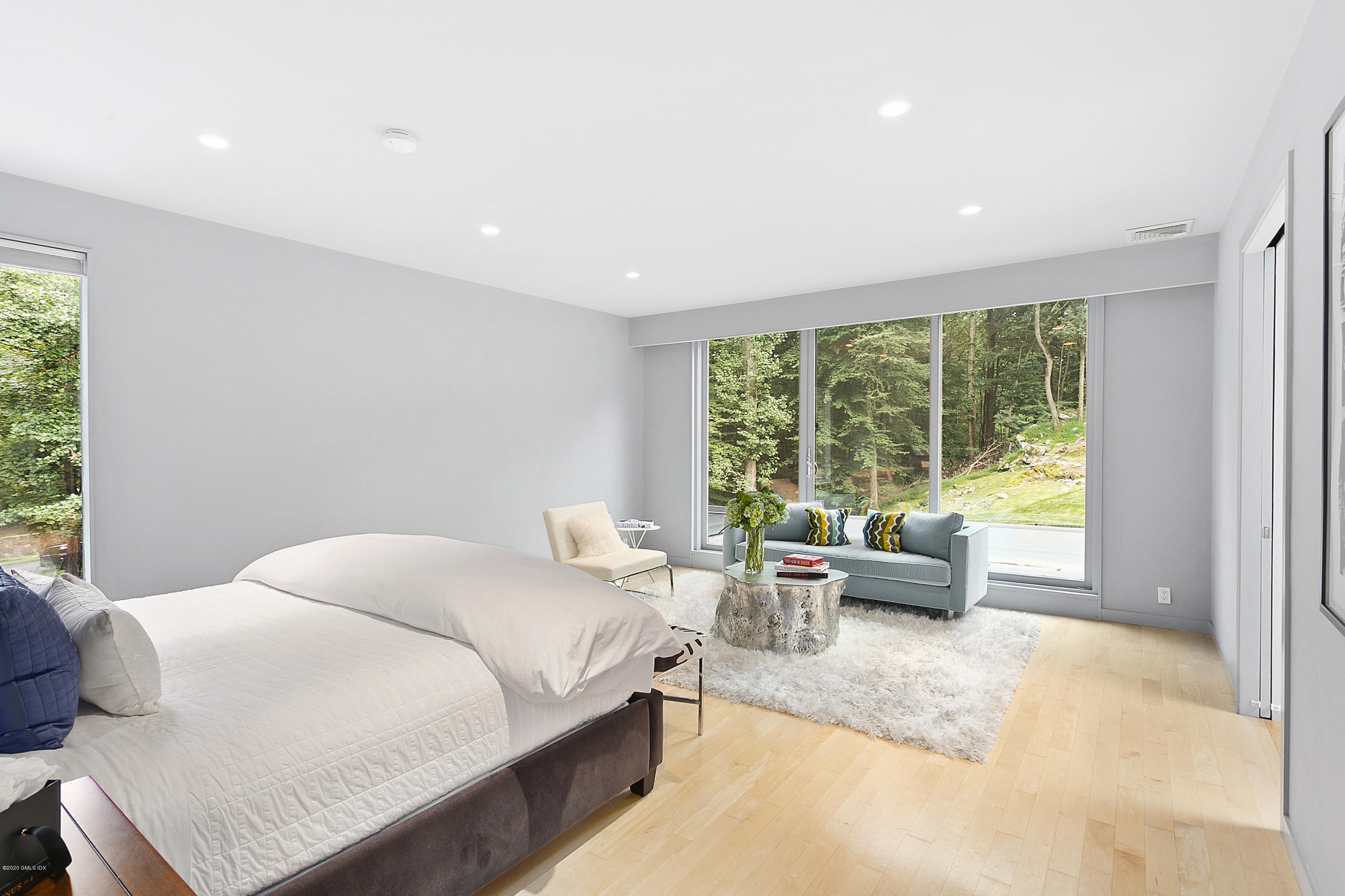 9 Chateau Ridge Drive Greenwich, CT 06831 - Photo 18 of 34 a bedroom with a bed and large windows