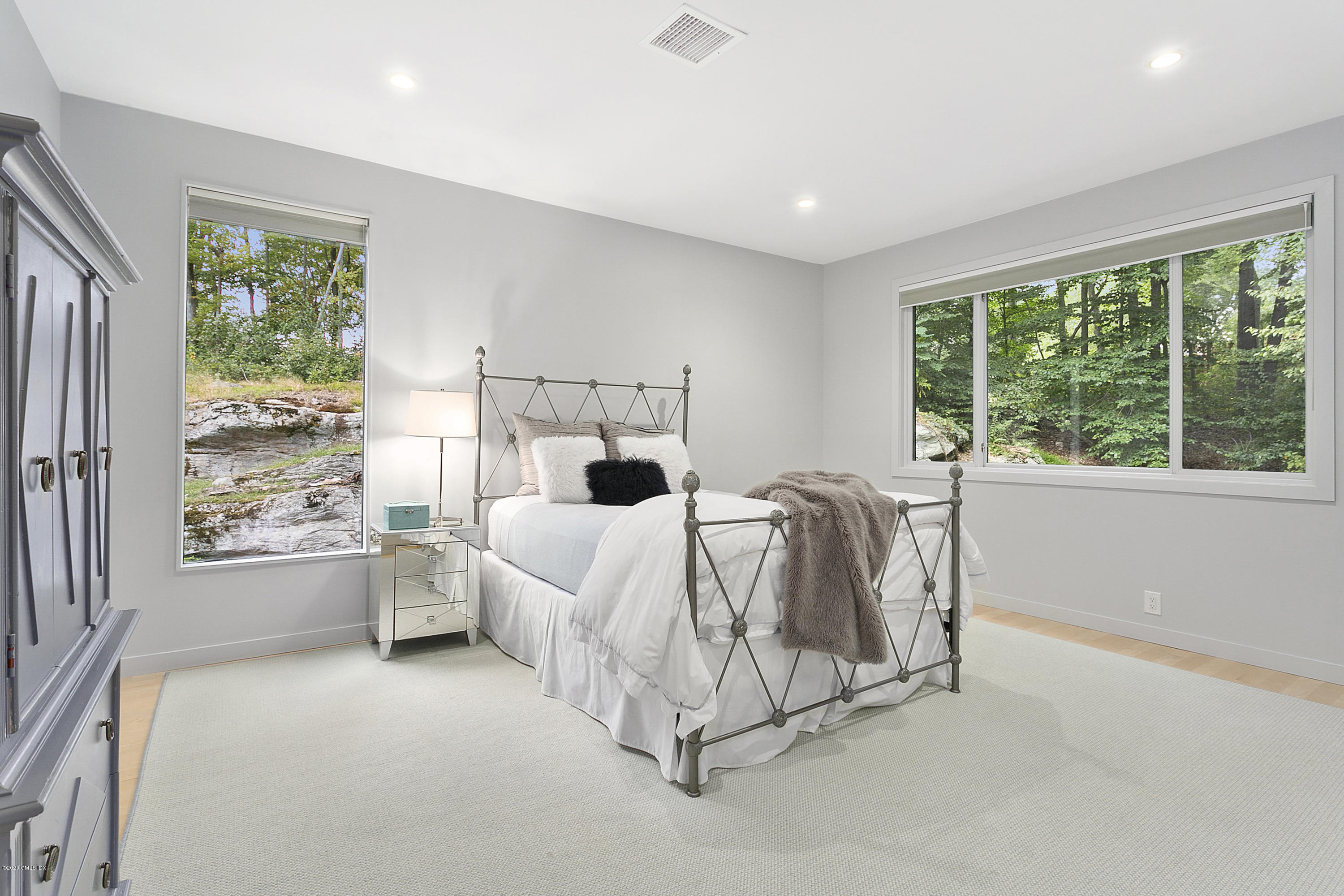 9 Chateau Ridge Drive Greenwich, CT 06831 - Photo 22 of 34 a bed room with a bed and a large window