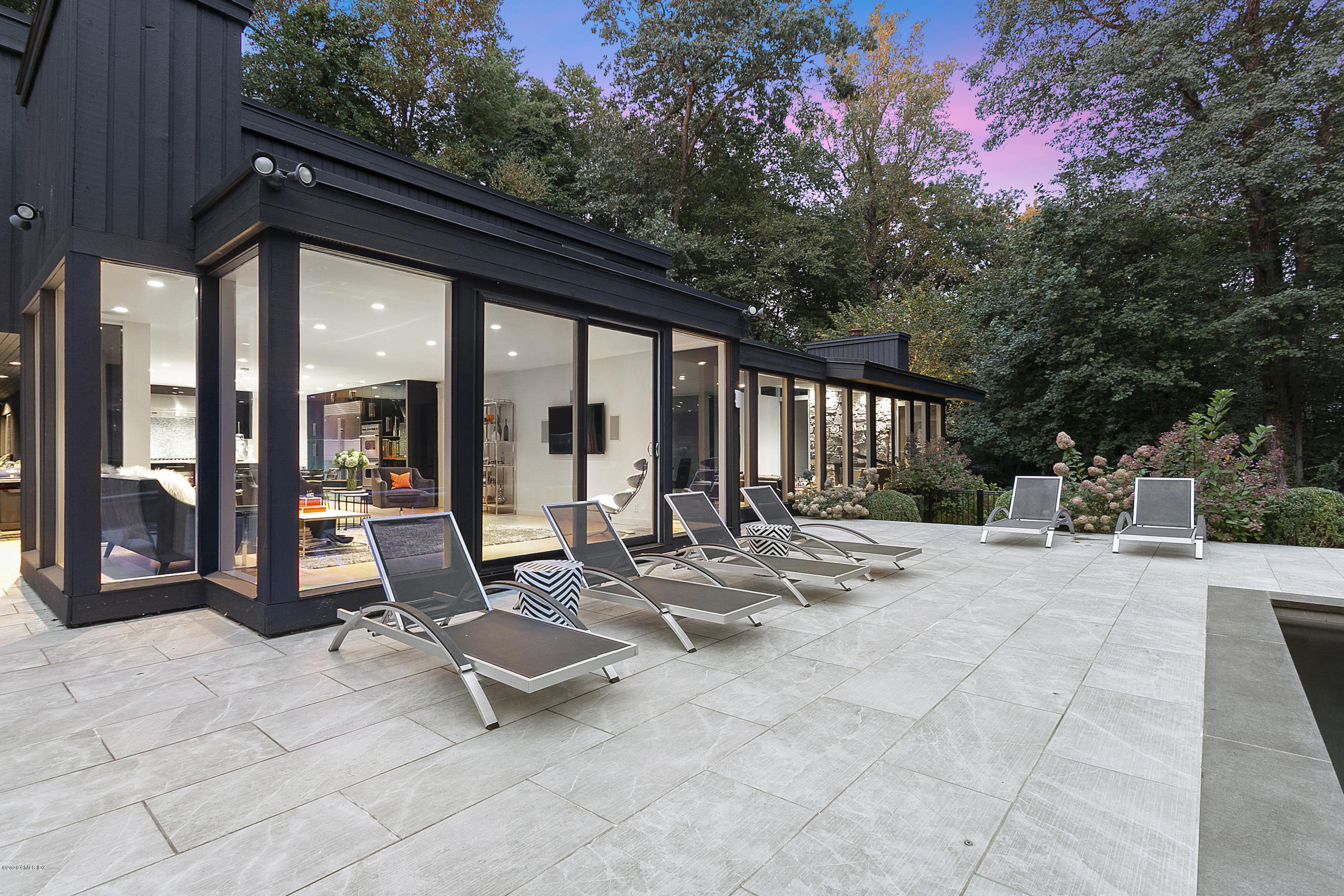 9 Chateau Ridge Drive Greenwich, CT 06831 - Photo 24 of 34 a view of a patio with a dining table and chairs with wooden floor and fence
