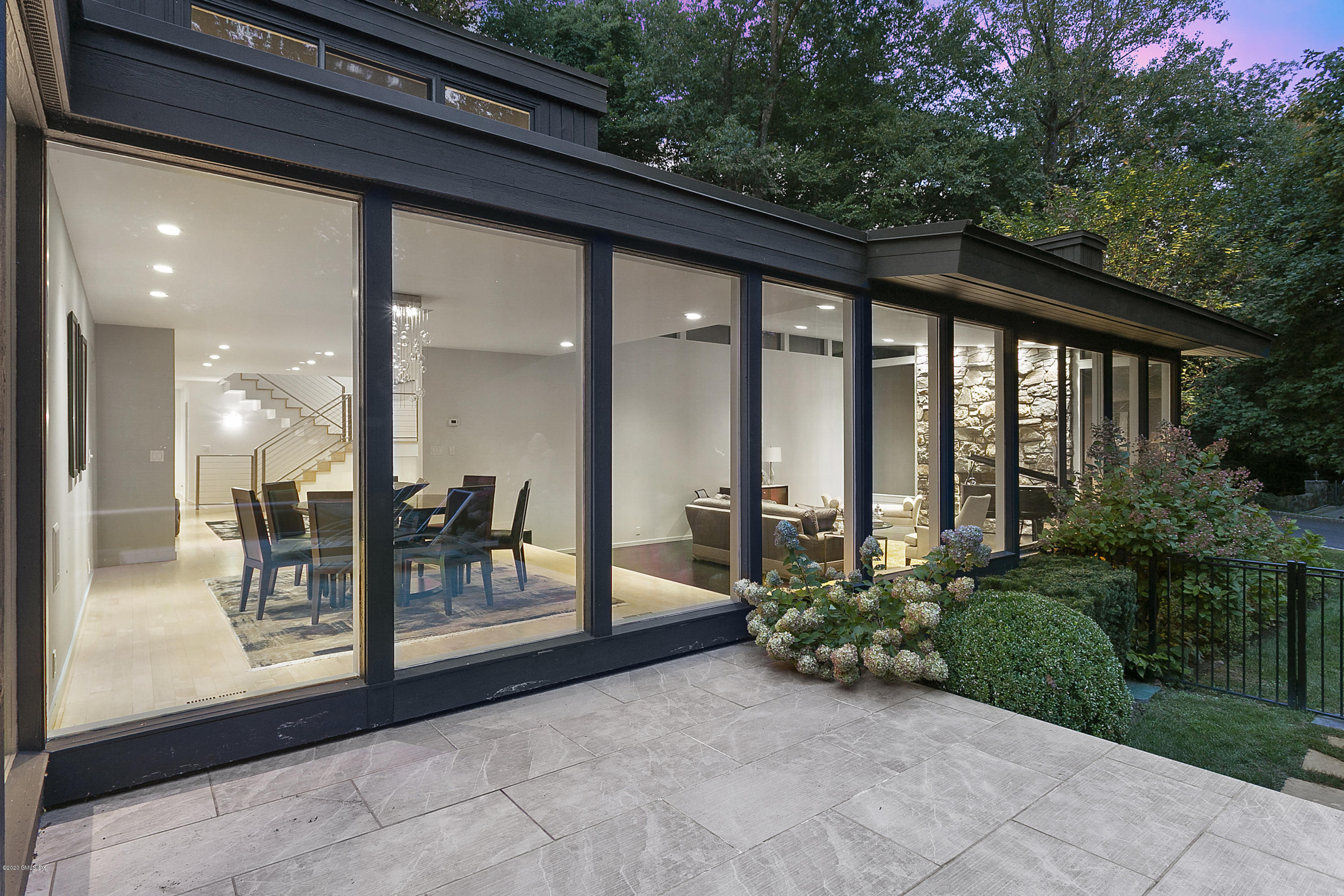 9 Chateau Ridge Drive Greenwich, CT 06831 - Photo 25 of 34 a view of a porch with chairs and floor to ceiling window