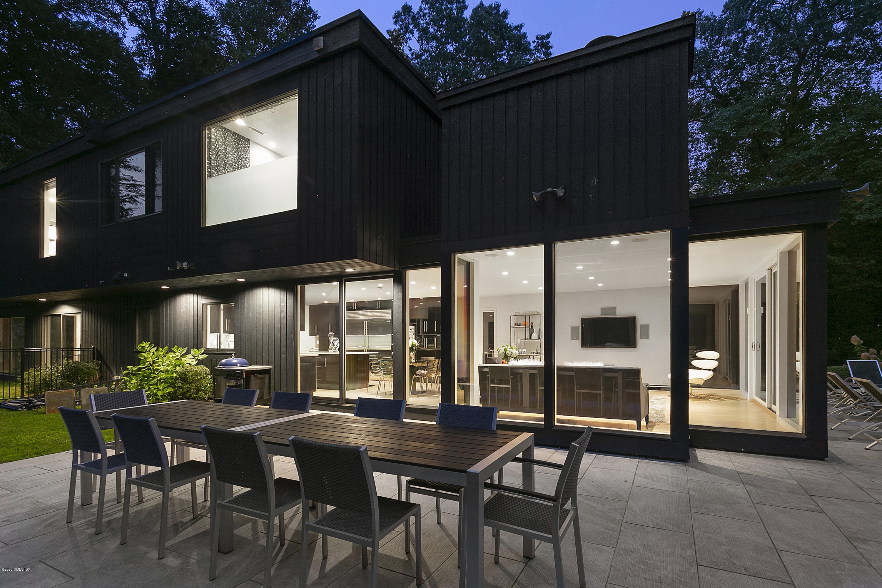 9 Chateau Ridge Drive Greenwich, CT 06831 - Photo 27 of 34 a patio with a table and chairs and potted plants