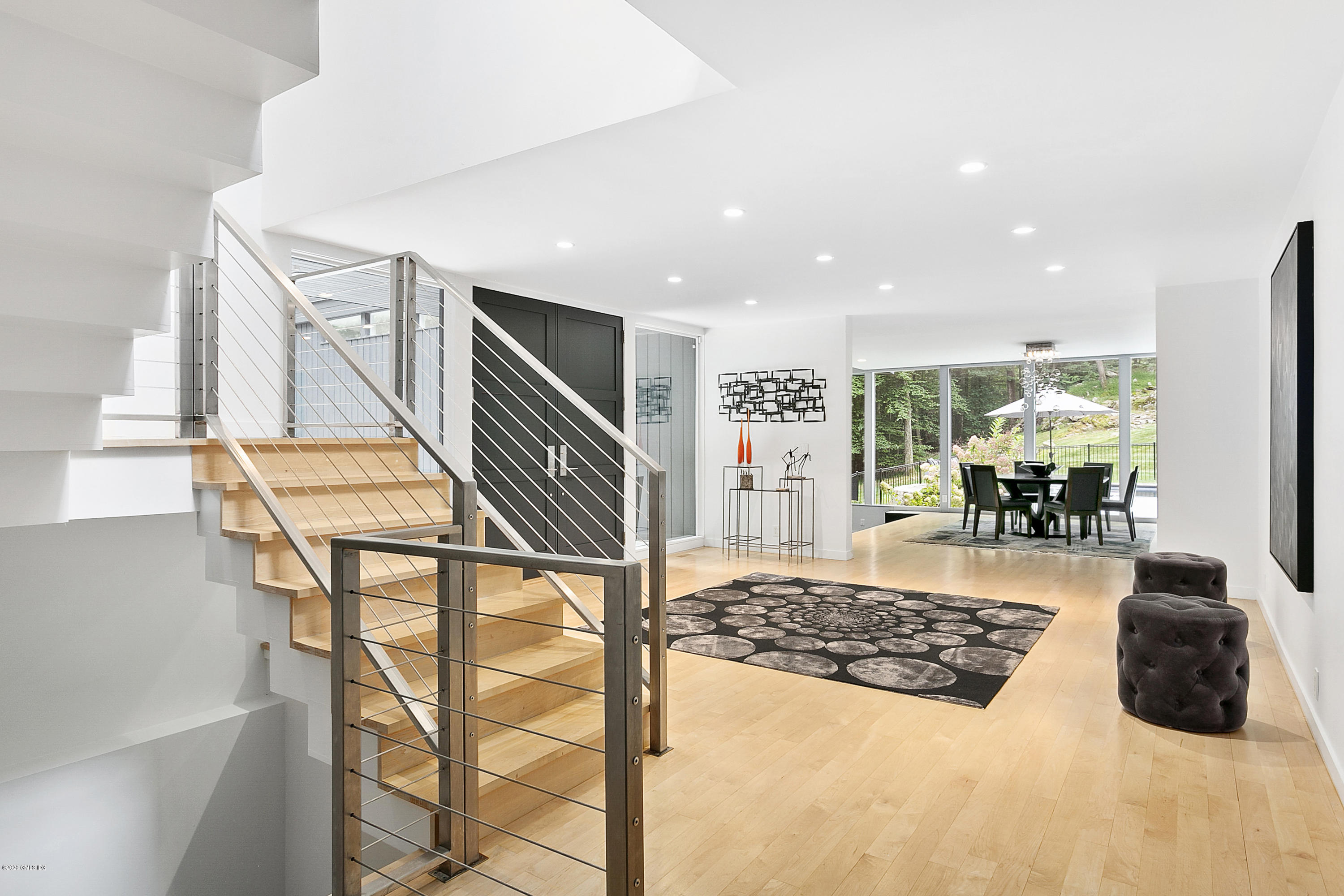 9 Chateau Ridge Drive Greenwich, CT 06831 - Photo 3 of 34 a living room with a couch and a potted plant