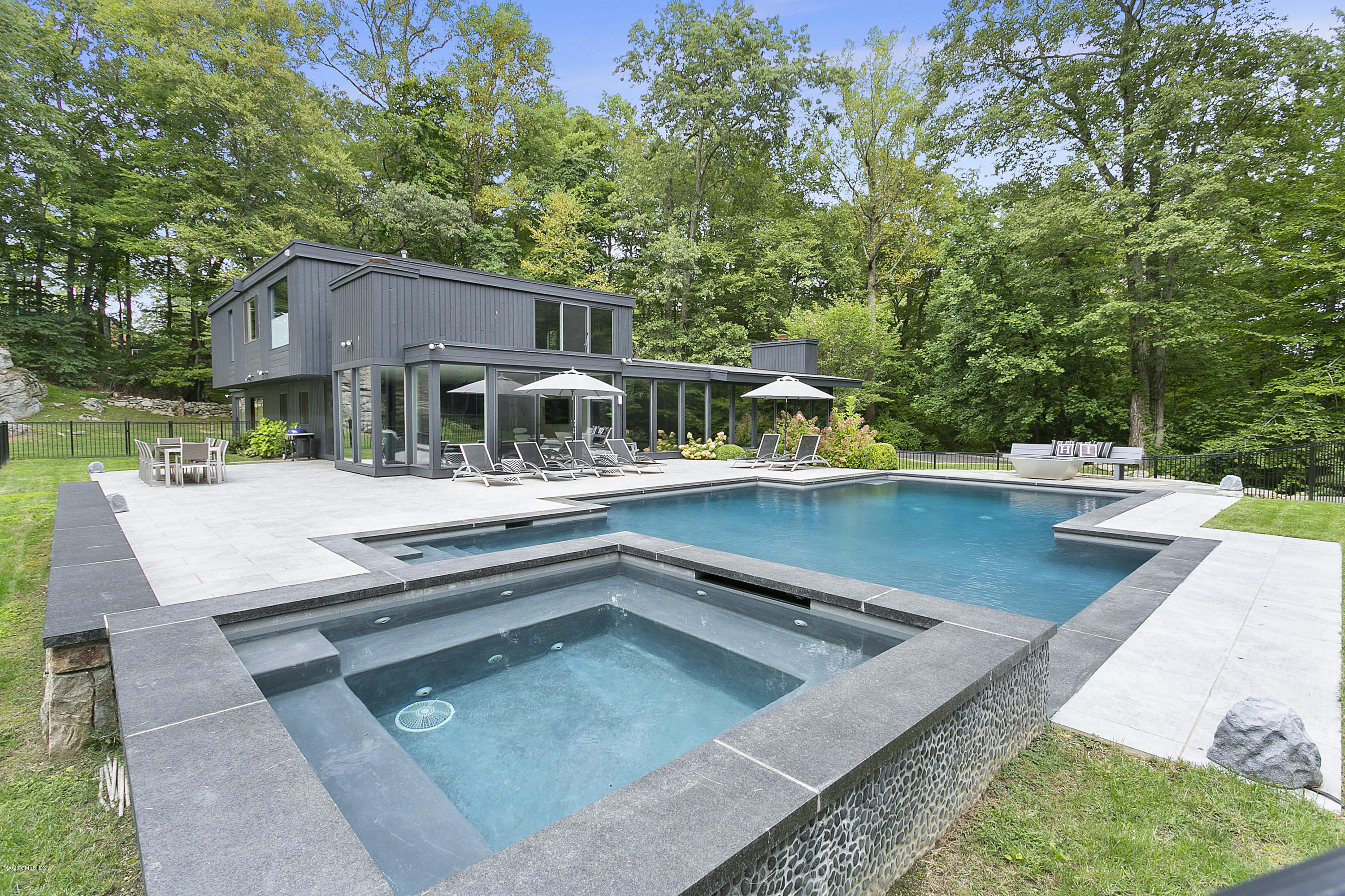 9 Chateau Ridge Drive Greenwich, CT 06831 - Photo 31 of 34 a view of a house with pool and chairs