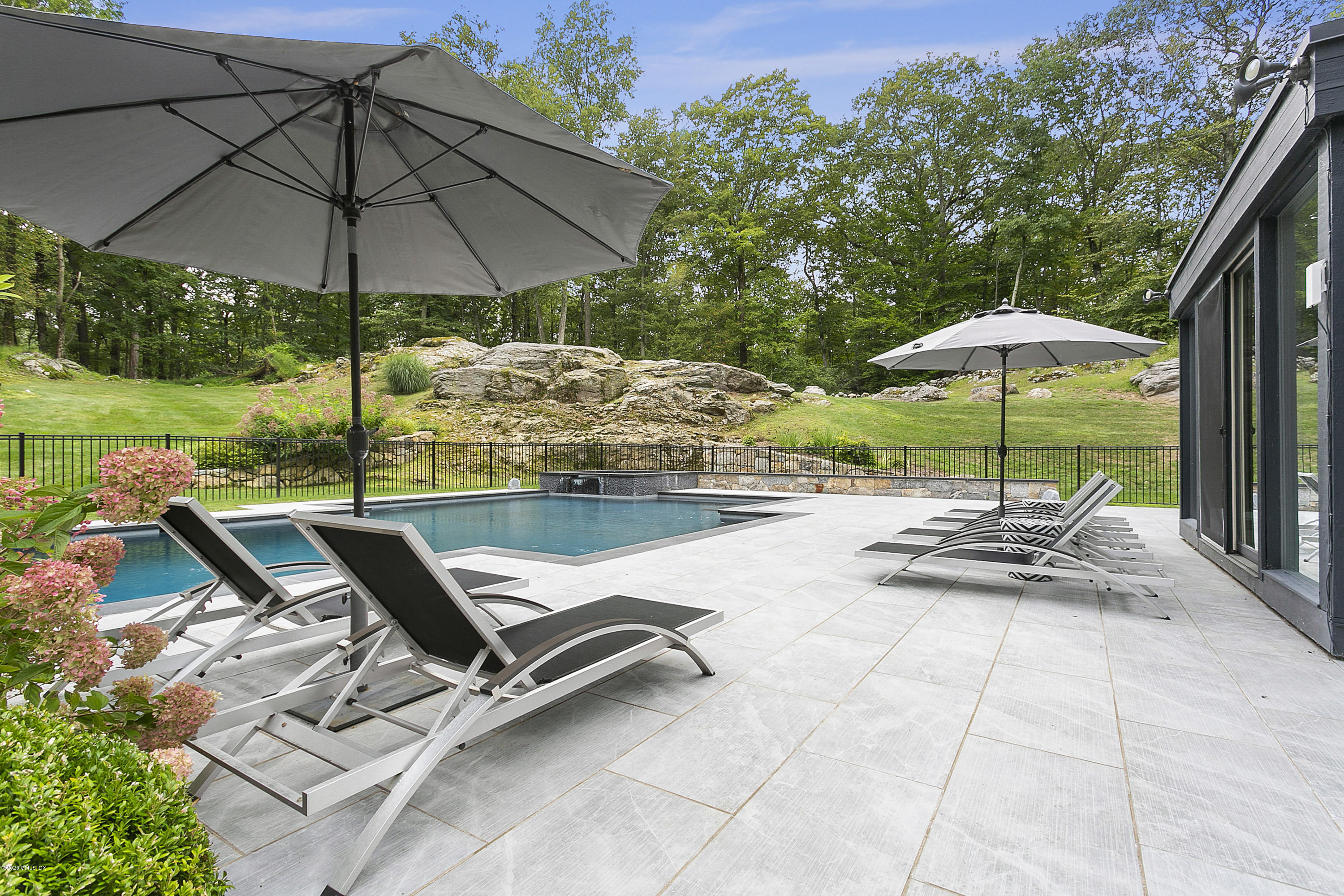 9 Chateau Ridge Drive Greenwich, CT 06831 - Photo 32 of 34 a view of pool with table and chairs under an umbrella