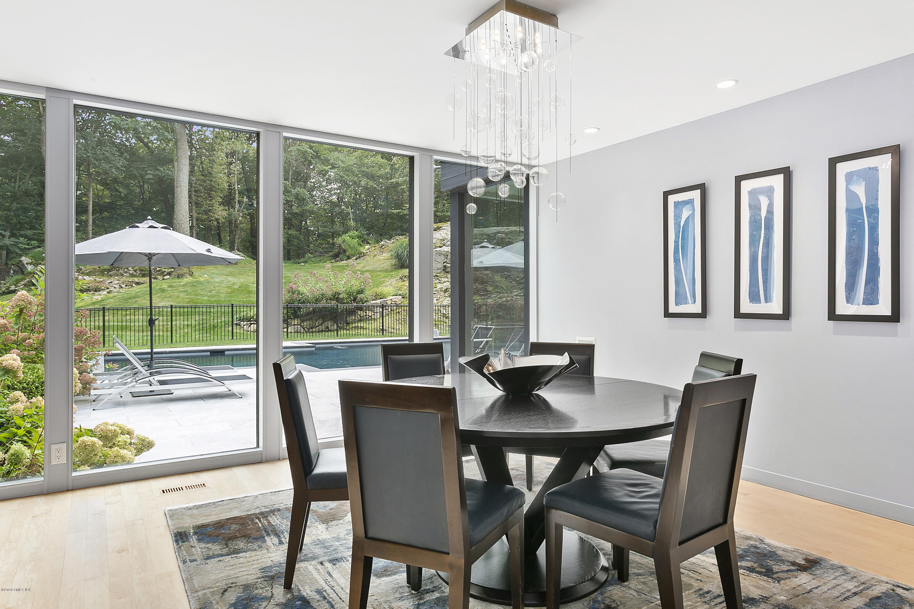 9 Chateau Ridge Drive Greenwich, CT 06831 - Photo 9 of 34 a dining room with furniture a chandelier and wooden floor