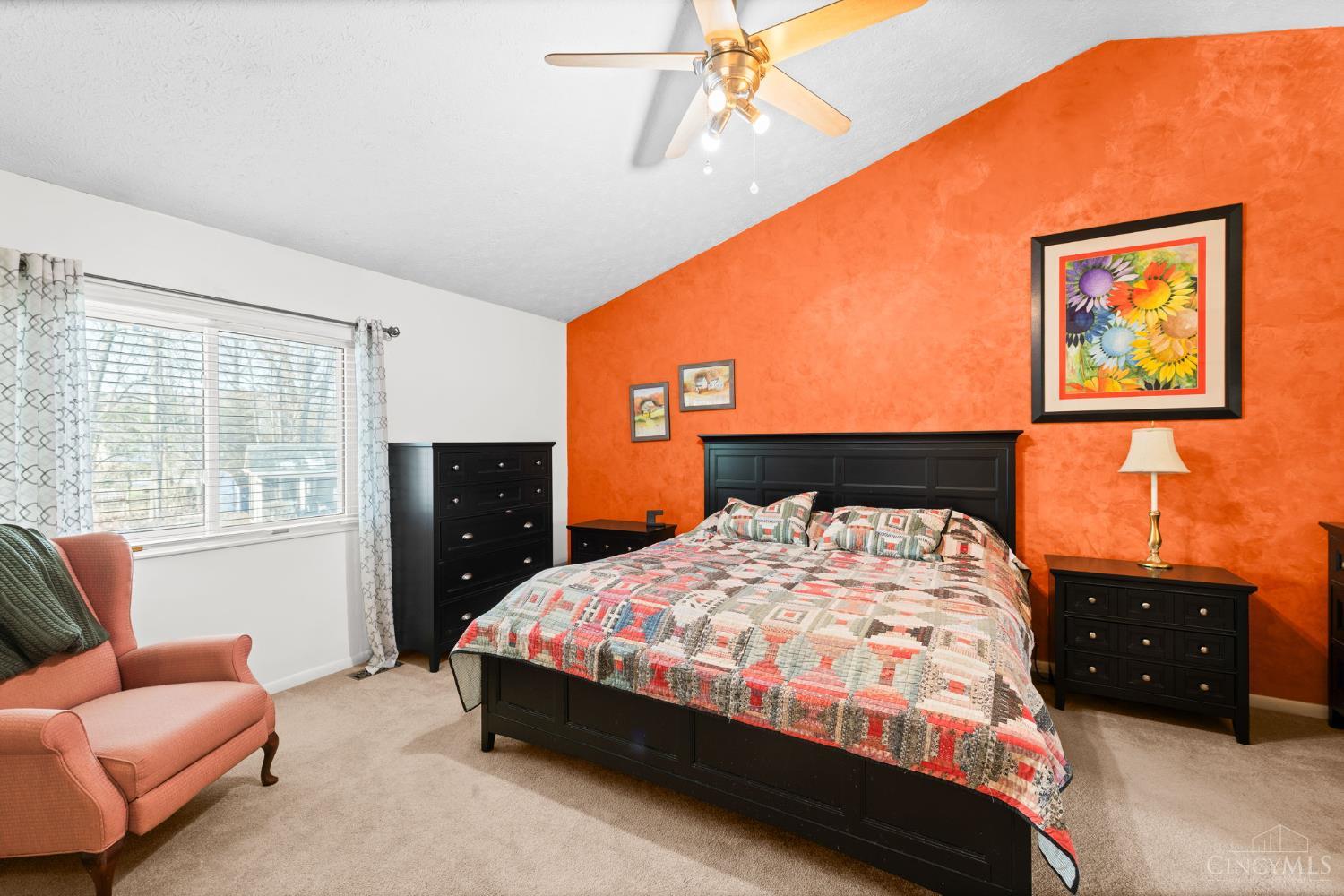 724 Regent Road Cincinnati, OH 45245 - Photo 27 of 67 Primary bedroom suite with vaulted ceiling and view of the rear yard. Primary bath and closets are connected to make the perfect suite.