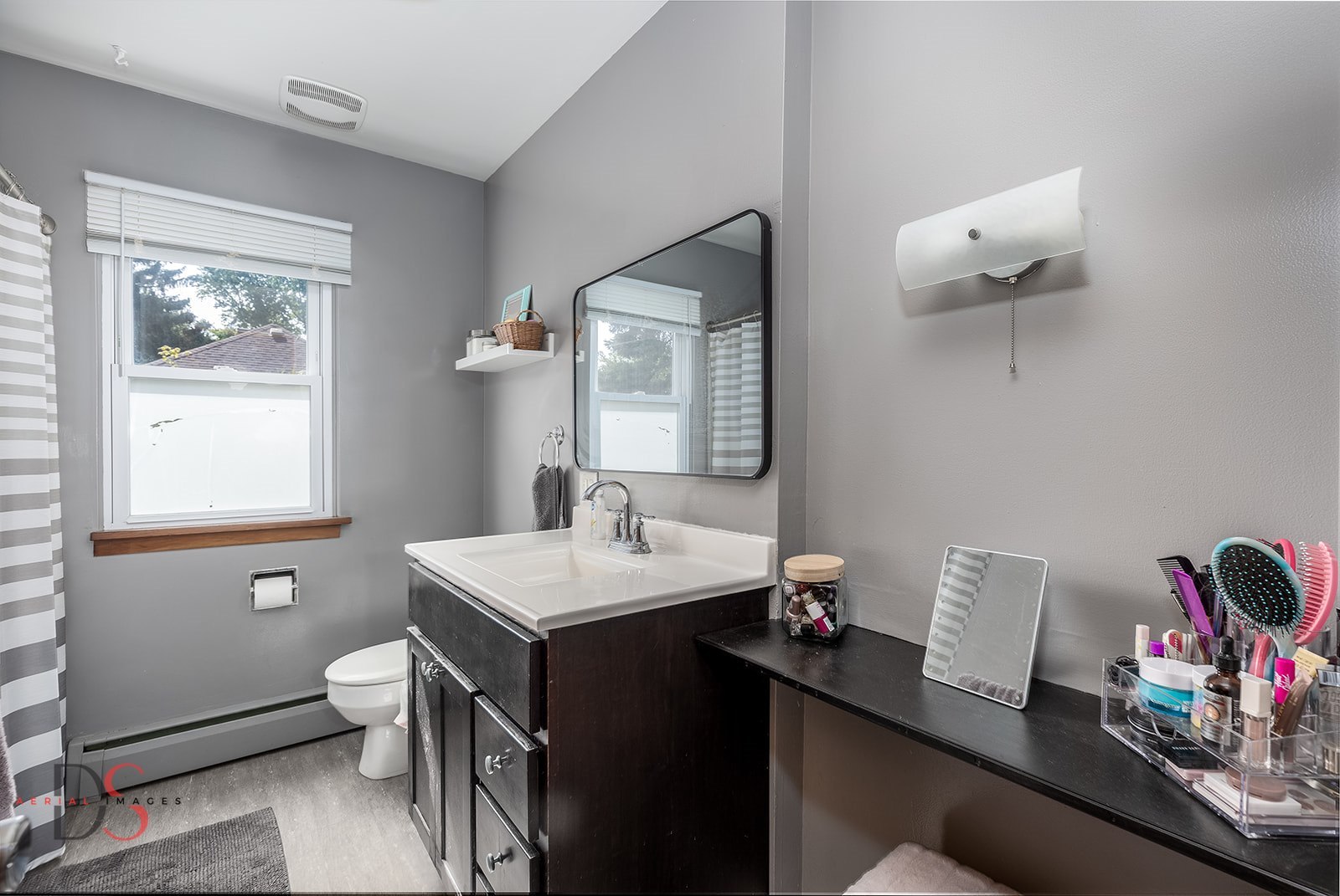 927 Clark Street Marseilles, IL 61341 - Photo 17 of 25 a bathroom with a sink vanity mirror and toilet