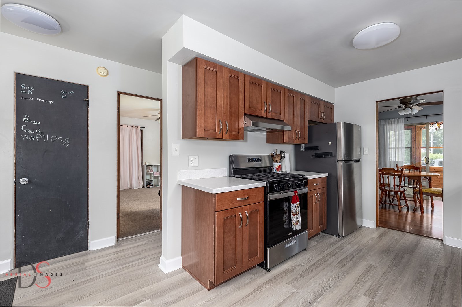 927 Clark Street Marseilles, IL 61341 - Photo 10 of 25 a kitchen with stainless steel appliances granite countertop a stove top oven a refrigerator and a sink with wooden floor